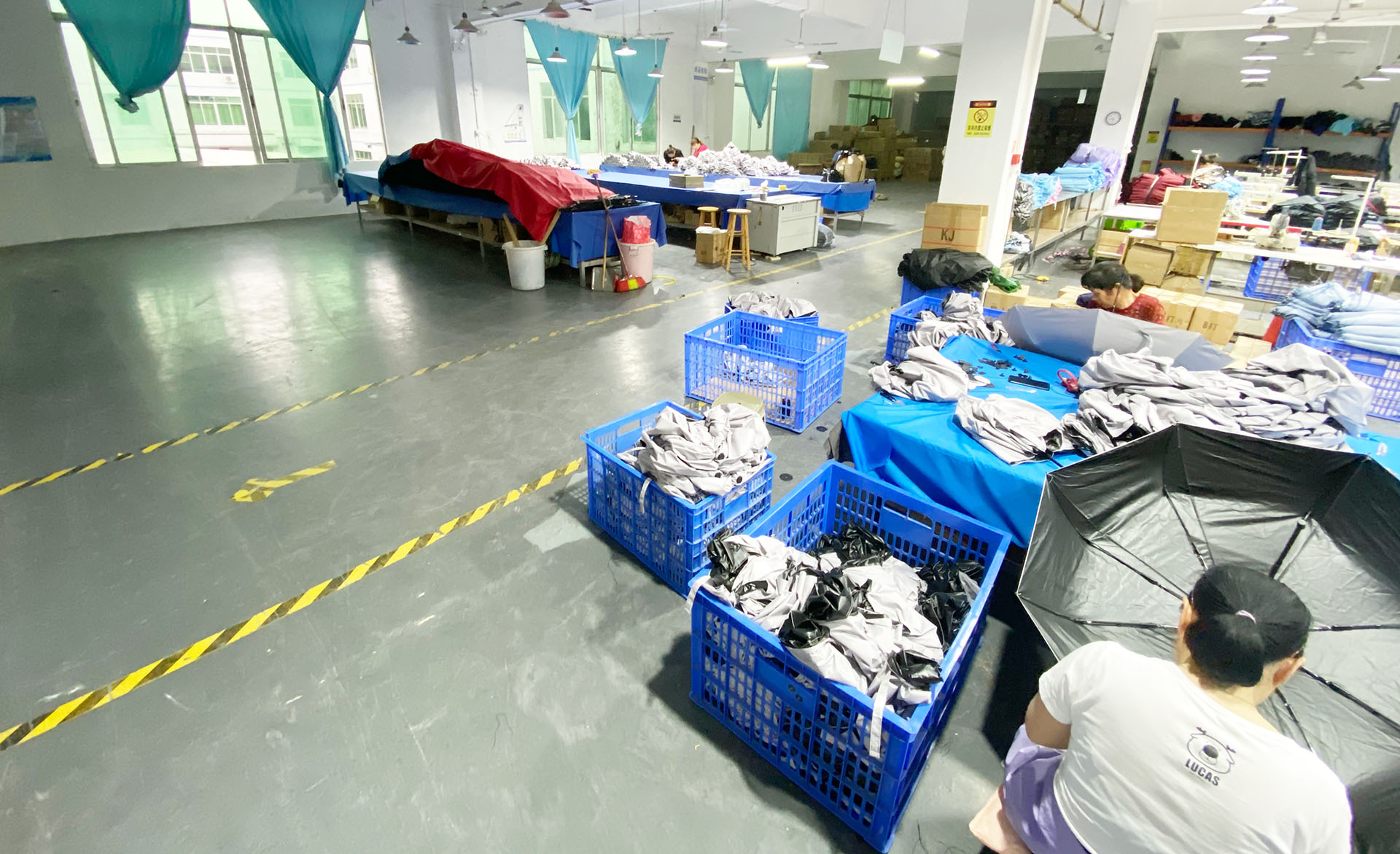 YJ Umbrella artwork and sample support team checking logo placement on an umbrella